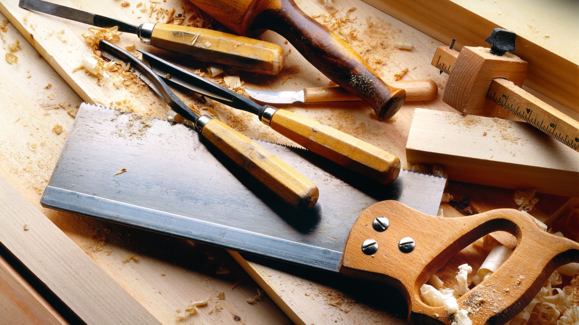 Woodworking tools and wood shavings on a workbench
